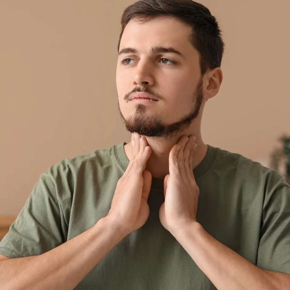 Young man with thyroid gland problem at home